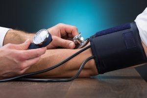 Cropped,Image,Of,Male,Doctor,Checking,Blood,Pressure,Of,Patient