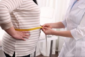 Nutritionist,Measuring,Overweight,Woman's,Waist,With,Tape,In,Clinic,,Closeup